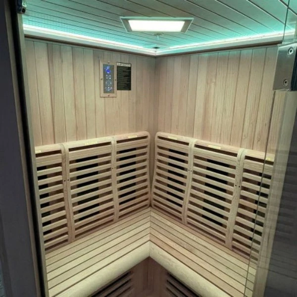 Infrared sauna interior with wall heating panels, corner bench and digital control
