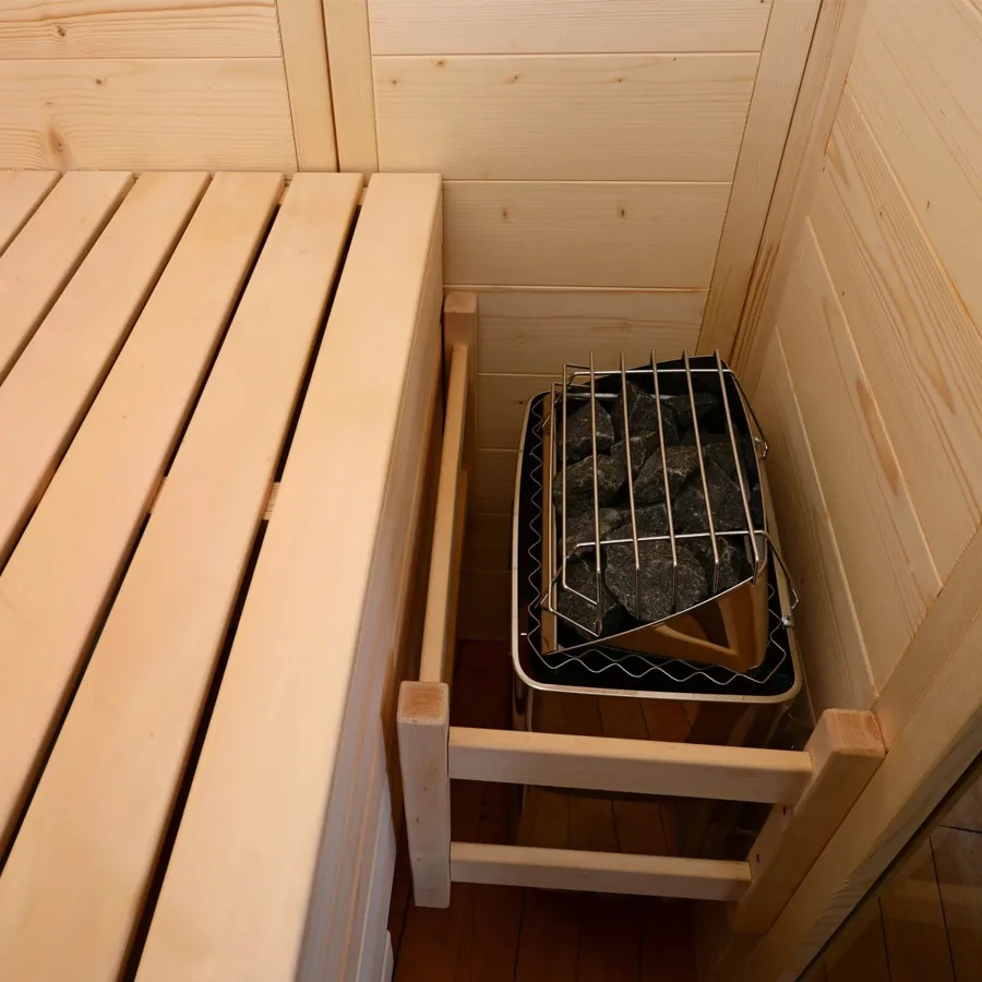 Stone sauna heater inside a wooden sauna room