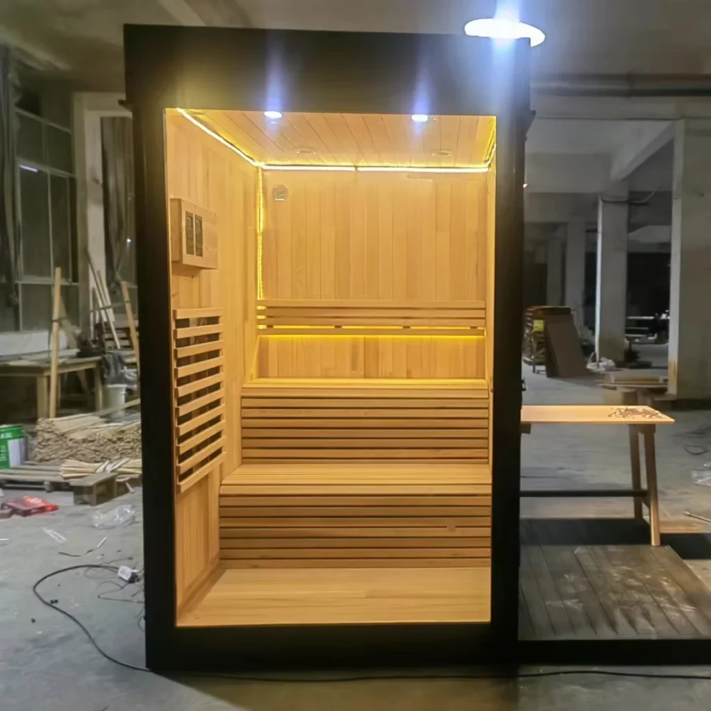 Completed infrared sauna cabin showing the timber bench and interior heater panels